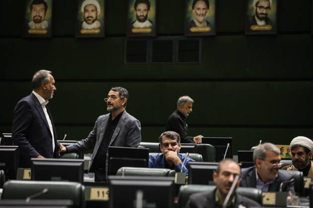 October 25, 2026, Tehran, Iran: Two suited lawmakers stand talking beneath framed portraits as other members sit at their desks in the chamber at the Islamic Consultative Assembly in Tehran, Iran, on October 25, 2026. The Islamic Consultative Assembly resumed an open sitting in its Tehran chamber with a mix of in-person and remote participation, according to parliamentary reporting. Tehran Iran - ZUMAi98_ 20261025_zih_i98_045 Copyright: xIcanax