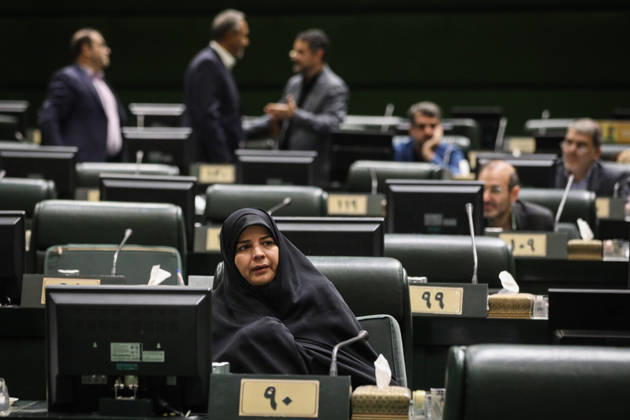 October 25, 2026, Tehran, Iran: A woman in a black chador sits at her numbered desk while lawmakers converse in the rows behind her at the Islamic Consultative Assembly in Tehran, Iran, on October 25, 2026. Speaker Mohammad Bagher Ghalibaf chaired the October 25 session, which combined physical attendance at the Islamic Consultative Assembly with participation by video link. Tehran Iran - ZUMAi98_ 20261025_zih_i98_053 Copyright: xIcanax