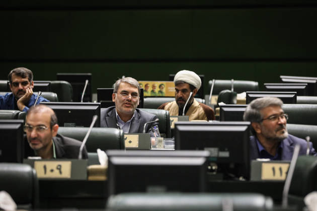 October 25, 2026, Tehran, Iran: Several seated male lawmakers and a white-turbaned cleric occupy rows of green benches with digital desk displays at the Islamic Consultative Assembly in Tehran, Iran, on October 25, 2026. The Iranian parliament held a hybrid open sitting, with some lawmakers attending in the Tehran chamber and others participating remotely, according to parliamentary reports. Tehran Iran - ZUMAi98_ 20261025_zih_i98_051 Copyright: xIcanax