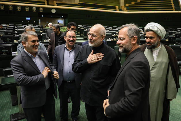 October 25, 2026, Tehran, Iran: Mohammad Bagher Ghalibaf puts a hand on his chest as he talks with suited men and a cleric standing in a group at the Islamic Consultative Assembly in Tehran, Iran, on October 25, 2026. The Islamic Consultative Assembly resumed an open sitting in its Tehran chamber with a mix of in-person and remote participation, according to parliamentary reporting. Tehran Iran - ZUMAi98_ 20261025_zih_i98_058 Copyright: xIcanax