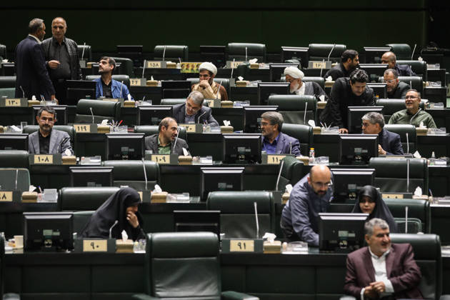 October 25, 2026, Tehran, Iran: Lawmakers occupy scattered rows of numbered green desks, some speaking to colleagues and others reading documents at the Islamic Consultative Assembly in Tehran, Iran, on October 25, 2026. Parliamentary reports said more than two-thirds of lawmakers joined the October 25 open sitting of the Islamic Consultative Assembly, attending either in person or remotely. Tehran Iran - ZUMAi98_ 20261025_zih_i98_060 Copyright: xIcanax