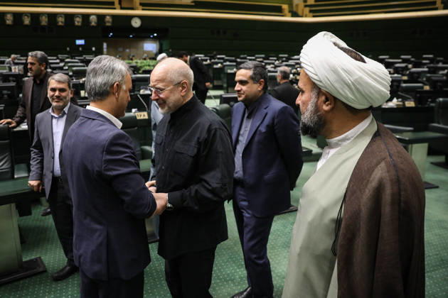 October 25, 2026, Tehran, Iran: Mohammad Bagher Ghalibaf shakes hands with a suited man while a white-turbaned cleric watches from the foreground at the Islamic Consultative Assembly in Tehran, Iran, on October 25, 2026. The Iranian parliament held a hybrid open sitting, with some lawmakers attending in the Tehran chamber and others participating remotely, according to parliamentary reports. Tehran Iran - ZUMAi98_ 20261025_zih_i98_065 Copyright: xIcanax