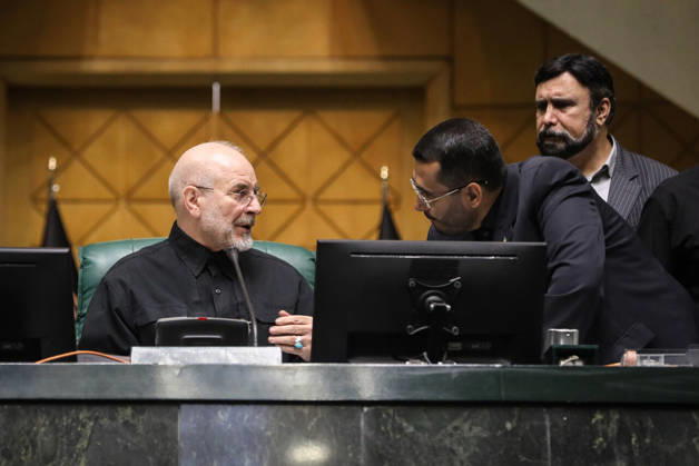 October 25, 2026, Tehran, Iran: Mohammad Bagher Ghalibaf speaks with a man leaning across the presiding desk while another official stands behind them at the Islamic Consultative Assembly in Tehran, Iran, on October 25, 2026. Speaker Mohammad Bagher Ghalibaf chaired the October 25 session, which combined physical attendance at the Islamic Consultative Assembly with participation by video link. Tehran Iran - ZUMAi98_ 20261025_zih_i98_068 Copyright: xIcanax