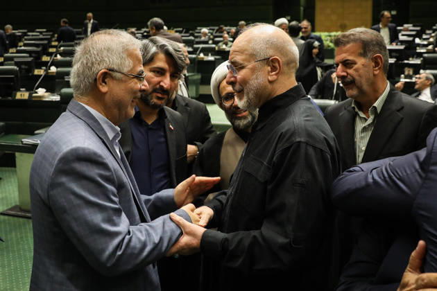 October 25, 2026, Tehran, Iran: A gray-haired man clasps Mohammad Bagher Ghalibaf s hands in greeting as other lawmakers watch behind them at the Islamic Consultative Assembly in Tehran, Iran, on October 25, 2026. Speaker Mohammad Bagher Ghalibaf chaired the October 25 session, which combined physical attendance at the Islamic Consultative Assembly with participation by video link. Tehran Iran - ZUMAi98_ 20261025_zih_i98_071 Copyright: xIcanax