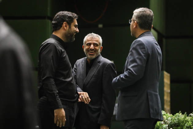 October 25, 2026, Tehran, Iran: A man dressed in black speaks with a gray-haired suited lawmaker while a third man stands between them at the Islamic Consultative Assembly in Tehran, Iran, on October 25, 2026. The Islamic Consultative Assembly resumed an open sitting in its Tehran chamber with a mix of in-person and remote participation, according to parliamentary reporting. Tehran Iran - ZUMAi98_ 20261025_zih_i98_073 Copyright: xIcanax