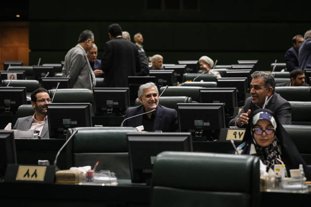 October 25, 2026, Tehran, Iran: Lawmakers sit at their desks with monitors and microphones as several men stand in conversation farther back at the Islamic Consultative Assembly in Tehran, Iran, on October 25, 2026. The Islamic Consultative Assembly resumed an open sitting in its Tehran chamber with a mix of in-person and remote participation, according to parliamentary reporting. Tehran Iran - ZUMAi98_ 20261025_zih_i98_074 Copyright: xIcanax
