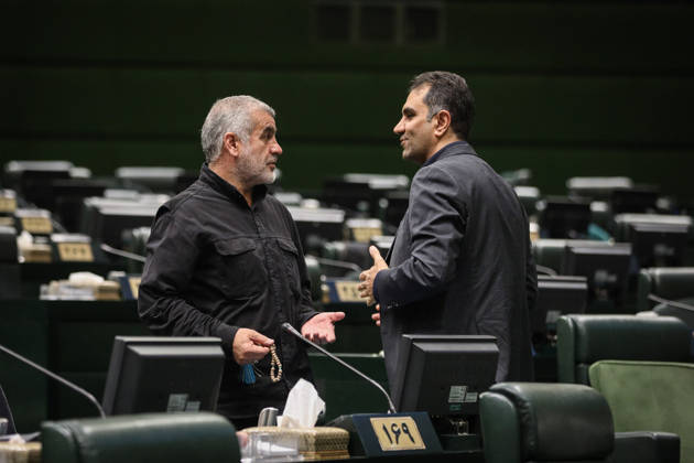 October 25, 2026, Tehran, Iran: A gray-bearded lawmaker holds a document and gestures while talking to a suited colleague next to his desk at the Islamic Consultative Assembly in Tehran, Iran, on October 25, 2026. Parliamentary reports said more than two-thirds of lawmakers joined the October 25 open sitting of the Islamic Consultative Assembly, attending either in person or remotely. Tehran Iran - ZUMAi98_ 20261025_zih_i98_076 Copyright: xIcanax