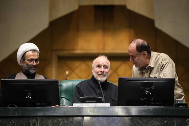 October 25, 2026, Tehran, Iran: Mohammad Bagher Ghalibaf sits at the presiding desk between a turbaned cleric and a man leaning over a monitor at the Islamic Consultative Assembly in Tehran, Iran, on October 25, 2026. Parliamentary reports said more than two-thirds of lawmakers joined the October 25 open sitting of the Islamic Consultative Assembly, attending either in person or remotely. Tehran Iran - ZUMAi98_ 20261025_zih_i98_077 Copyright: xIcanax
