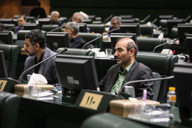 October 25, 2026, Tehran, Iran: Two male lawmakers sit behind parliamentary desk monitors, one wearing a dark jacket over a green shirt at the Islamic Consultative Assembly in Tehran, Iran, on October 25, 2026. Speaker Mohammad Bagher Ghalibaf chaired the October 25 session, which combined physical attendance at the Islamic Consultative Assembly with participation by video link. Tehran Iran - ZUMAi98_ 20261025_zih_i98_085 Copyright: xIcanax