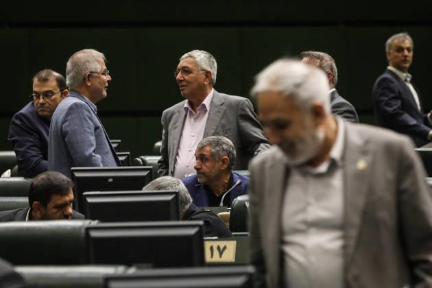 October 25, 2026, Tehran, Iran: Two gray-haired men stand talking among the seats while another lawmaker crosses the foreground of the chamber at the Islamic Consultative Assembly in Tehran, Iran, on October 25, 2026. The Islamic Consultative Assembly resumed an open sitting in its Tehran chamber with a mix of in-person and remote participation, according to parliamentary reporting. Tehran Iran - ZUMAi98_ 20261025_zih_i98_089 Copyright: xIcanax