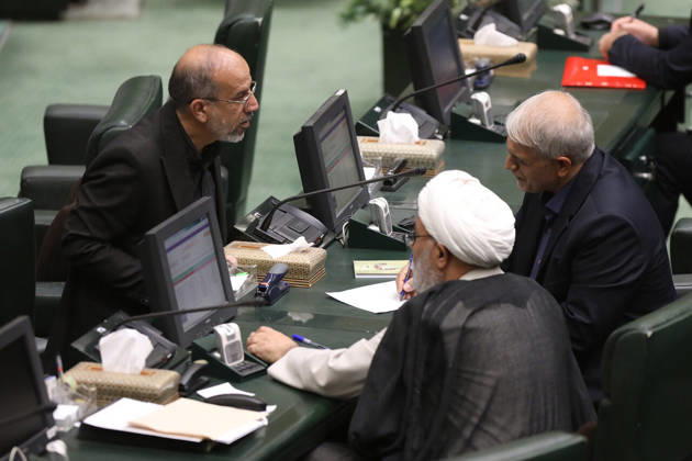 October 25, 2026, Tehran, Iran: Three male lawmakers confer across a row of desks fitted with desktop screens and microphones at the Islamic Consultative Assembly in Tehran, Iran, on October 25, 2026. Parliamentary reports said more than two-thirds of lawmakers joined the October 25 open sitting of the Islamic Consultative Assembly, attending either in person or remotely. Tehran Iran - ZUMAi98_ 20261025_zih_i98_111 Copyright: xIcanax