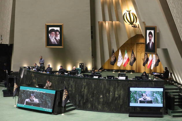 October 25, 2026, Tehran, Iran: The raised parliamentary dais is seen from the chamber floor beneath Iranian flags and two framed portraits at the Islamic Consultative Assembly in Tehran, Iran, on October 25, 2026. Speaker Mohammad Bagher Ghalibaf chaired the October 25 session, which combined physical attendance at the Islamic Consultative Assembly with participation by video link. Tehran Iran - ZUMAi98_ 20261025_zih_i98_117 Copyright: xIcanax