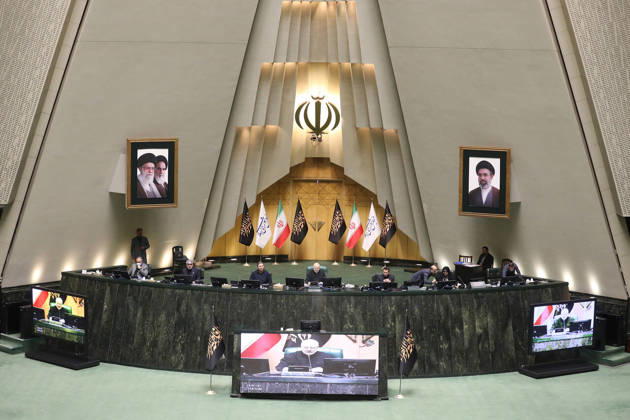 October 25, 2026, Tehran, Iran: The presiding platform appears beneath the national emblem and two framed portraits, with video displays at its base at the Islamic Consultative Assembly in Tehran, Iran, on October 25, 2026. The Islamic Consultative Assembly resumed an open sitting in its Tehran chamber with a mix of in-person and remote participation, according to parliamentary reporting. Tehran Iran - ZUMAi98_ 20261025_zih_i98_123 Copyright: xIcanax