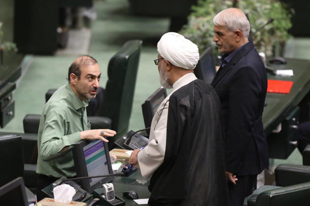 October 25, 2026, Tehran, Iran: A man in a pale green shirt talks to a white-turbaned cleric, with a gray-haired lawmaker standing behind them at the Islamic Consultative Assembly in Tehran, Iran, on October 25, 2026. Parliamentary reports said more than two-thirds of lawmakers joined the October 25 open sitting of the Islamic Consultative Assembly, attending either in person or remotely. Tehran Iran - ZUMAi98_ 20261025_zih_i98_126 Copyright: xIcanax