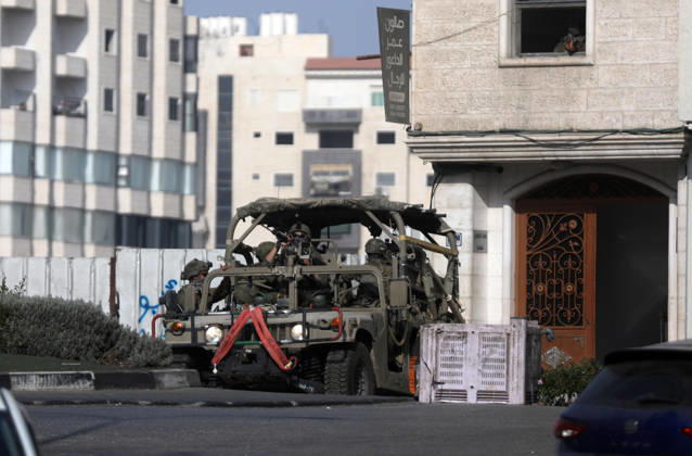 (261025) -- HEBRON, Oct. 25, 2026 -- An Israeli military vehicle patrols during a military operation in the West Bank city of Hebron, on Oct. 25, 2026. Israeli military operations continue in Hebron for the third consecutive day, amid ongoing closures and military movements. (Photo by Xinhua) MIDEAST-HEBRON-MILITARY-OPERATION MamounxWazwaz 