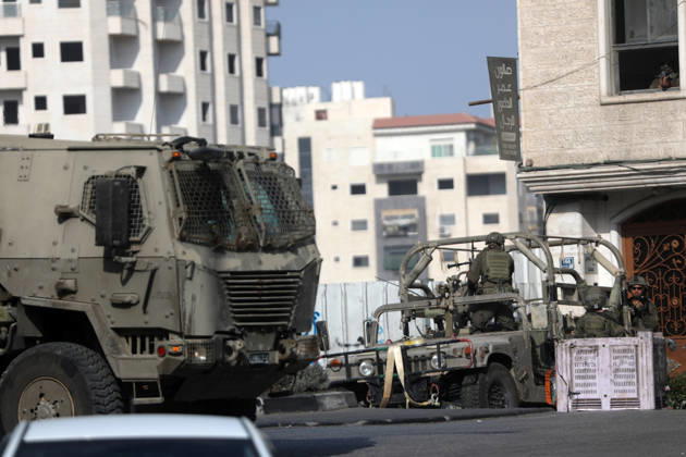 (261025) -- HEBRON, Oct. 25, 2026 -- Israeli military vehicles patrol during a military operation in the West Bank city of Hebron, on Oct. 25, 2026. Israeli military operations continue in Hebron for the third consecutive day, amid ongoing closures and military movements. (Photo by Xinhua) MIDEAST-HEBRON-MILITARY-OPERATION MamounxWazwaz 