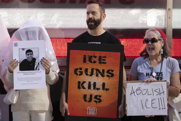 October 25, 2026, New York, New York, USA: Demonstrators with the anti-gun violence organization Gays Against Guns protest under the Times Square US Army Recruiting Station LED American flag to denounce U.S. Immigration and Customs Enforcement (ICE) and President Trump s immigrant detention and mass deportation policies. Protesters chant holding signs that read ICE GUNS KILL US ABOLISH ICE!!! People dressed in white shrouds are Human Beings, memorializing people killed by gun violence from Federal immigration agents by holding signs with their images and names. New York USA  - ZUMAr174 20261025_znp_r174_010 Copyright: xGinaxMxRandazzox