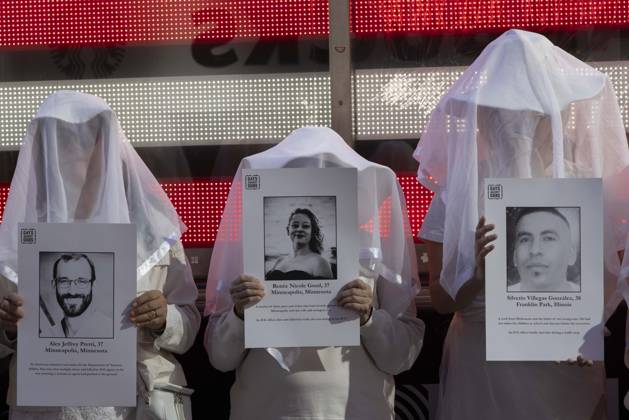 October 25, 2026, New York, New York, USA: People dressed in white shrouds are Human Beings, memorializing people killed by gun violence from Federal immigration agents by holding signs with the images and names of Alex Jeffrey Pretti Renee Nicole Good Silverio Villegas Gonzalez. Demonstrators with the anti-gun violence organization Gays Against Guns protest under the Times Square US Army Recruiting Station LED American flag to denounce U.S. Immigration and Customs Enforcement (ICE,) President Trump s immigrant detention and mass deportation policies. New York USA  - ZUMAr174 20261025_znp_r174_015 Copyright: xGinaxMxRandazzox
