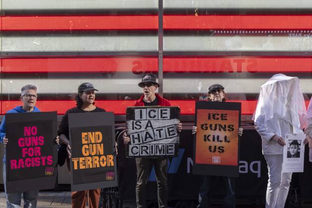 October 25, 2026, New York, New York, USA: Demonstrators with the anti-gun violence organization Gays Against Guns protest under the Times Square US Army Recruiting Station LED American flag to denounce U.S. Immigration and Customs Enforcement (ICE) and President Trump s immigrant detention and mass deportation policies. People dressed in white shrouds are Human Beings, memorializing people killed by gun violence from Federal immigration agents by holding signs with their images and names. Protesters chant holding signs that read NO GUNS FOR RACISTS END GUN TERROR ICE IS A HATE CRIME ICE GUNS KILL US. New York USA  - ZUMAr174 20261025_znp_r174_020 Copyright: xGinaxMxRandazzox