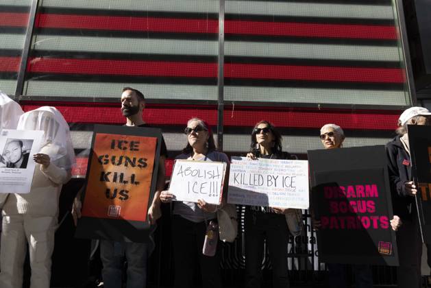 October 25, 2026, New York, New York, USA: Demonstrators with the anti-gun violence organization Gays Against Guns protest under the Times Square US Army Recruiting Station LED American flag to denounce U.S. Immigration and Customs Enforcement (ICE) and President Trump s immigrant detention and mass deportation policies. Protesters hold signs that read ICE GUNS KILL US ABOLISH ICE!!! KILLED BY ICE. People dressed in white shrouds are Human Beings, memorializing people killed by gun violence from Federal immigration agents by holding signs with their images and names. New York USA - ZUMAr174 20261025_znp_r174_003 Copyright: xGinaxMxRandazzox
