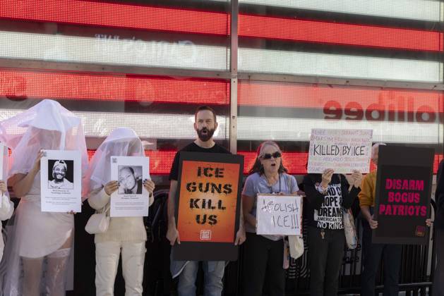 October 25, 2026, New York, New York, USA: Demonstrators with the anti-gun violence organization Gays Against Guns protest under the Times Square US Army Recruiting Station LED American flag to denounce U.S. Immigration and Customs Enforcement (ICE) and President Trump s immigrant detention and mass deportation policies. Protesters chant holding signs that read ICE GUNS KILL US ABOLISH ICE!!! KILLED BY ICE DISARM BOGUS PATRIOTS. People dressed in white shrouds are Human Beings, memorializing people killed by gun violence from Federal immigration agents by holding signs with their images and names. New York USA - ZUMAr174 20261025_znp_r174_007 Copyright: xGinaxMxRandazzox