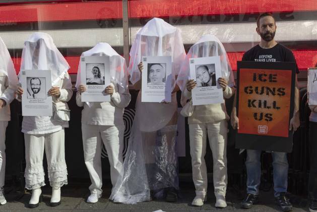 October 25, 2026, New York, New York, USA: People dressed in white shrouds are Human Beings, memorializing people killed by gun violence from Federal immigration agents by holding signs with the images and names of Alex Jeffrey Pretti Renee Nicole Good Silverio Villegas Gonzalez Jonah Neal. Demonstrators with the anti-gun violence organization Gays Against Guns protest under the Times Square US Army Recruiting Station LED American flag to denounce U.S. Immigration and Customs Enforcement (ICE,) President Trump s immigrant detention and mass deportation policies. Protesters hold signs that read ICE GUNS KILL US. New York USA - ZUMAr174 20261025_znp_r174_016 Copyright: xGinaxMxRandazzox