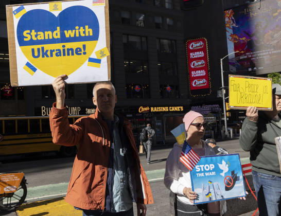 October 25, 2026, New York, New York, USA: Demonstrators stand in Times Square holding Ukrainian and American flags and signs that read Stand with Ukraine! STOP THE WAR! Fair Peace in Ukraine! New York USA - ZUMAr174 20261025_znp_r174_029 Copyright: xGinaxMxRandazzox