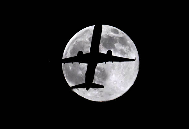 A plane crosses the waning Hunter Moon one day after a full moon, in Whittier California. ( ZUMApress.com) Whittier USA - ZUMA 20261025_zaf_u345_007 Copyright: xNickxUtx