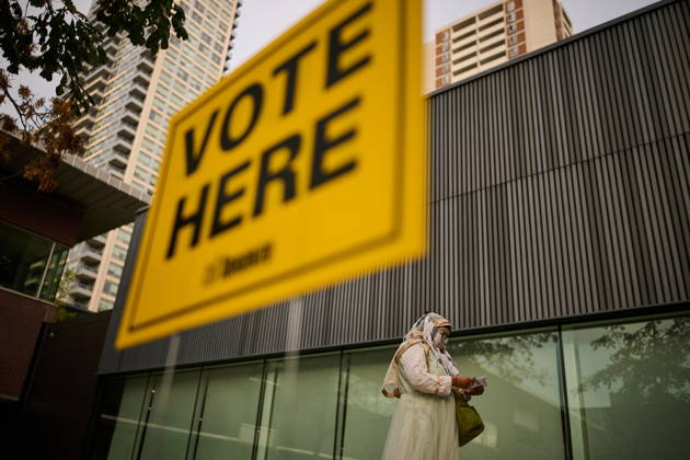 October 26, 2026, Toronto, On, Canada: People pass election signage as they head to the polls to vote in Toronto s municipal election, on Monday, Oct. 26, 2026. Toronto Canada  - ZUMAc35_ 20261026_zaf_c35_048 Copyright: xSammyxKoganx