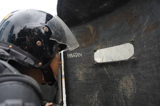 October 28, 2026, Jakarta, Indonesia: An Indonesian police officer is seen behind a scratched protective face shield as student protesters gather during a demonstration at Bundaran HI Jakarta Indonesia - ZUMAm265 20261028_zip_m265_012 Copyright: xAndrixMunazirx