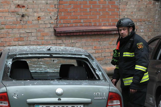 A rescuer approaches a car parked outside an apartment block on Oleksandra Polia Avenue damaged by a Russian drone strike in Dnipro, Ukraine, on October 30, 2026. The Russian attack damaged at least five residential high-rise buildings and a school. More than 300 windows were shattered in the strike. (Photo by Mykola Miakshykov Ukrinform) Russian attack damages residential buildings and school in Dnipro  Copyright: xMykolaxMiakshykovx