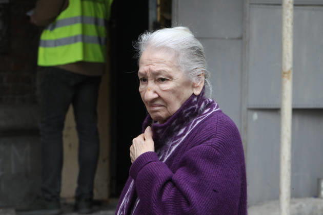 An elderly woman stands outside an apartment block on Oleksandra Polia Avenue damaged by a Russian drone strike in Dnipro, Ukraine, on October 30, 2026. The Russian attack damaged at least five residential high-rise buildings and a school. More than 300 windows were shattered in the strike. (Photo by Mykola Miakshykov Ukrinform) Russian attack damages residential buildings and school in Dnipro  Copyright: xMykolaxMiakshykovx